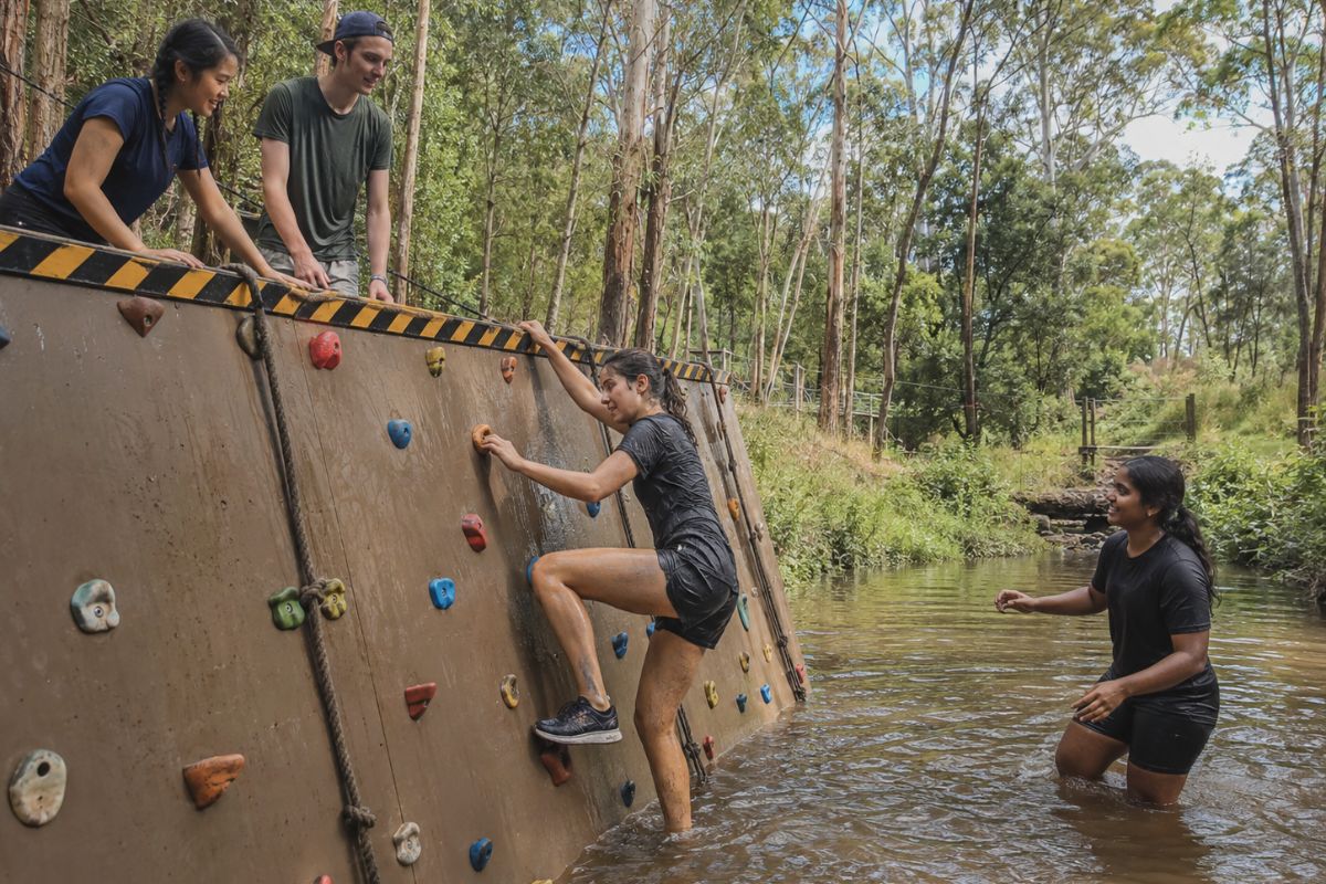 Student taking on an outdoor challenge during a school camp at Woodhouse